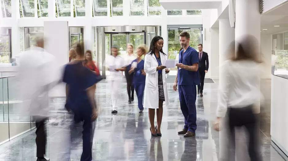 Hospital staff walking through a medical facility, intentionally blurred to look artistic